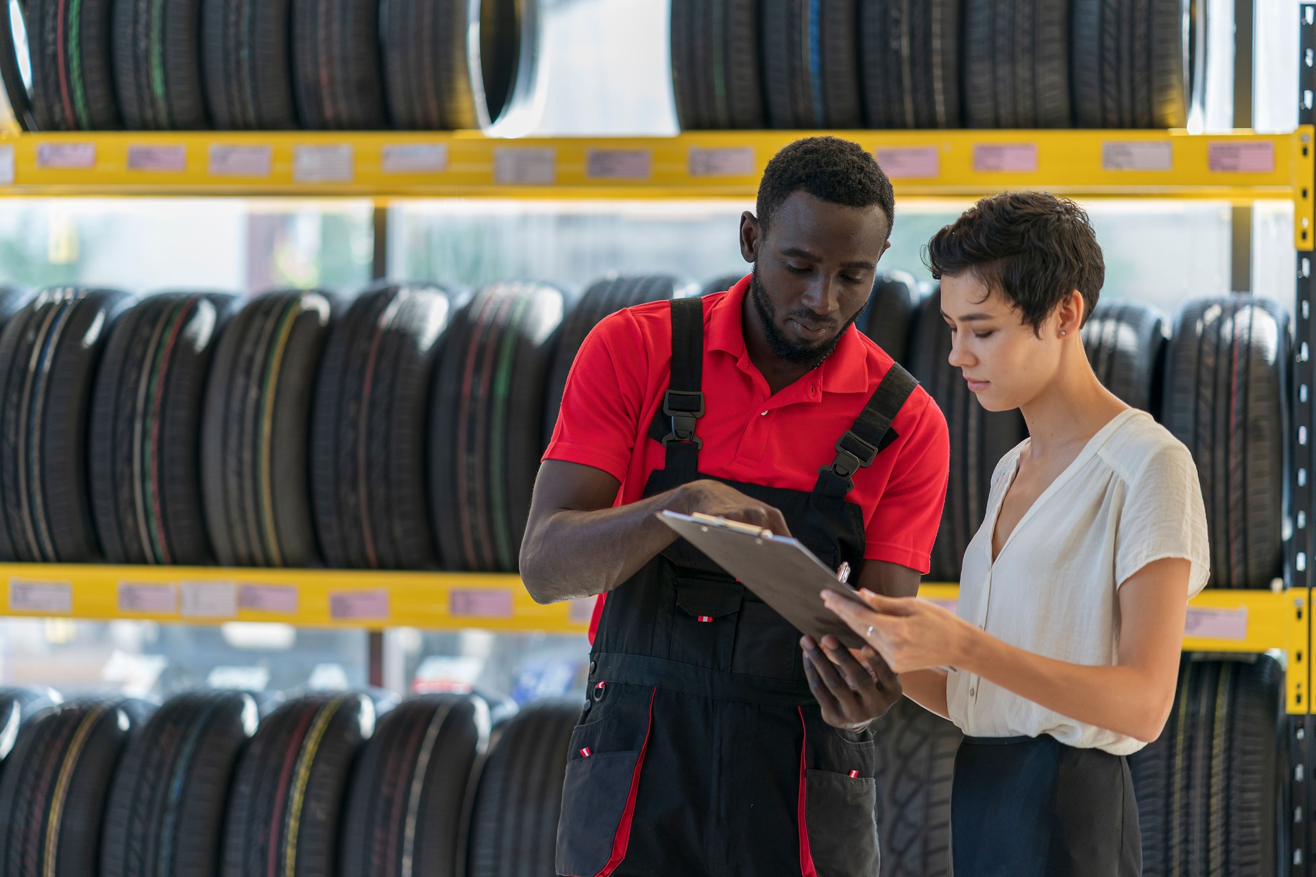 A mechanic talking to female customer